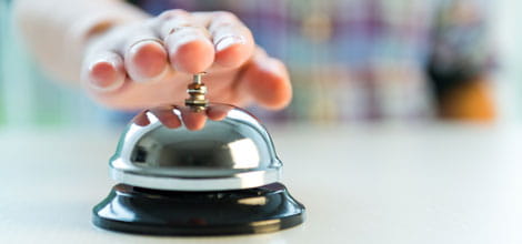Hand ringing hotel bell for attention 